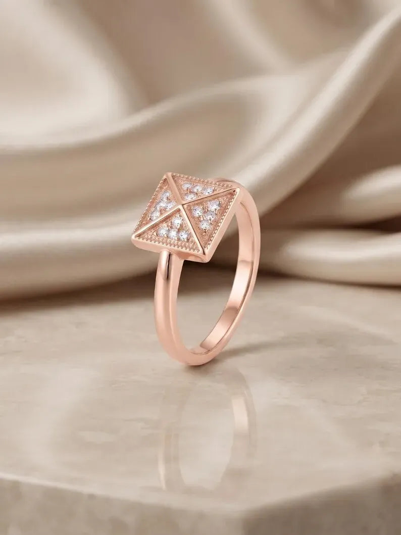 Side angle view of rose gold sterling silver pyramid ring with pave crystal triangles