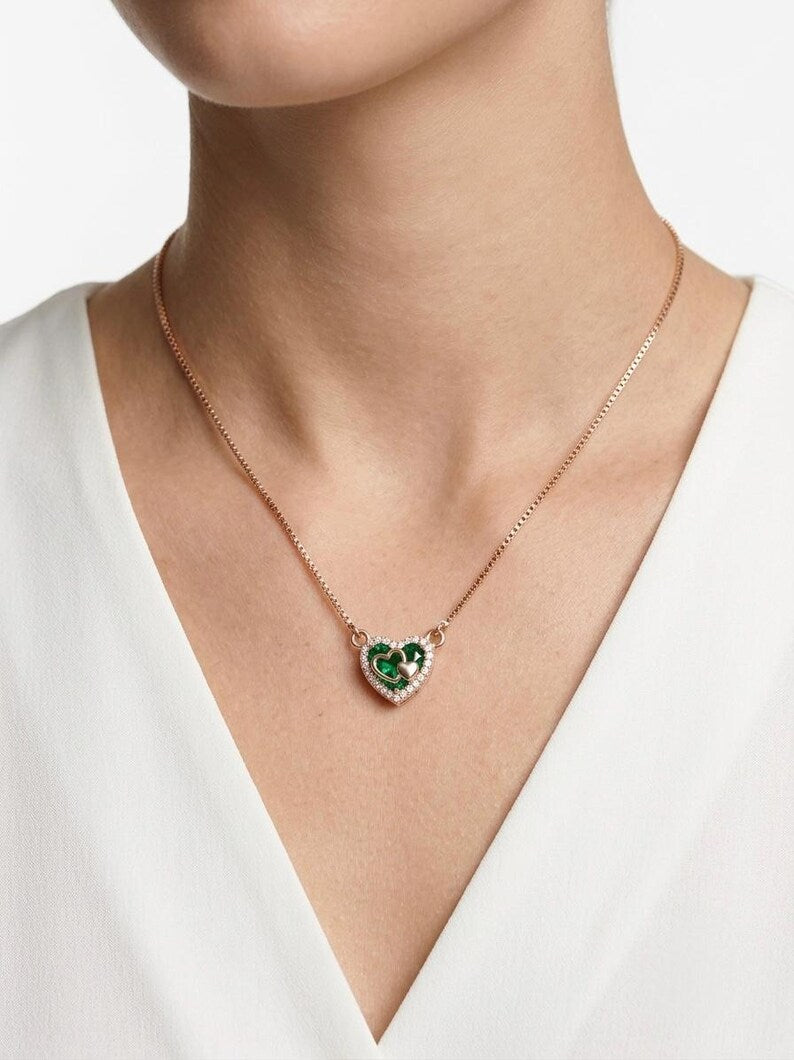 Woman wearing rose gold green heart necklace