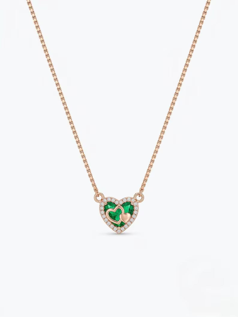 Close-up of green heart stone and zircon halo