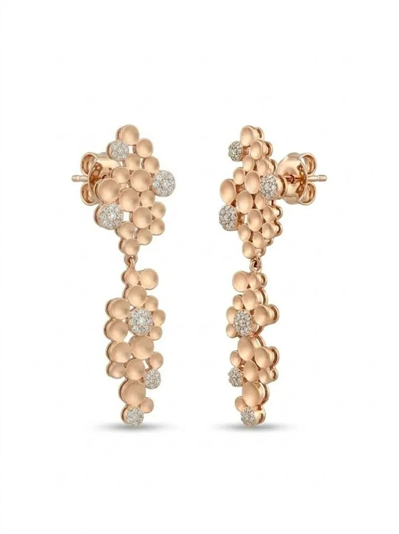 A pair of rose gold dangle earrings with textured, clustered floral designs accented by small clear gemstones, shown against a plain white background.