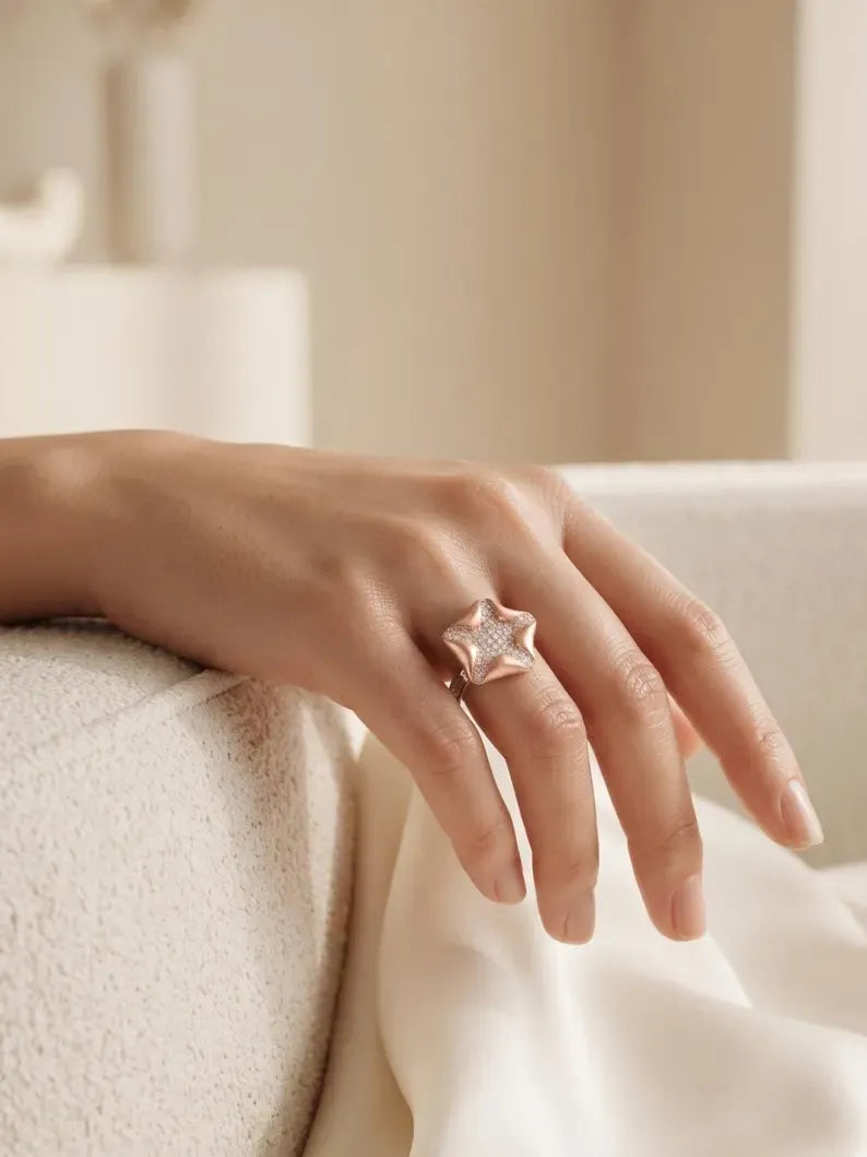 Rose gold plated CZ starfish ring on hand, showcasing stunning design of sterling silver rings for women.