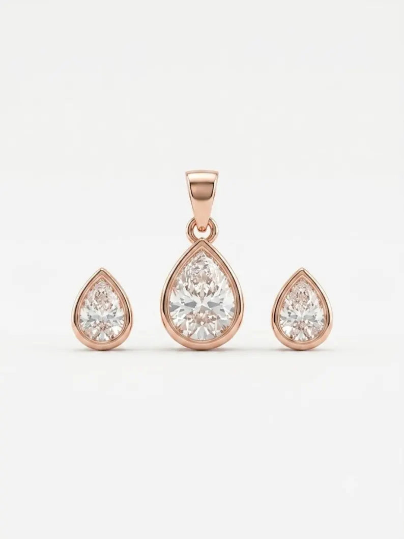 Rose gold jewelry set featuring a teardrop-shaped pendant and two matching stud earrings with clear gemstones, displayed on a clean white background.