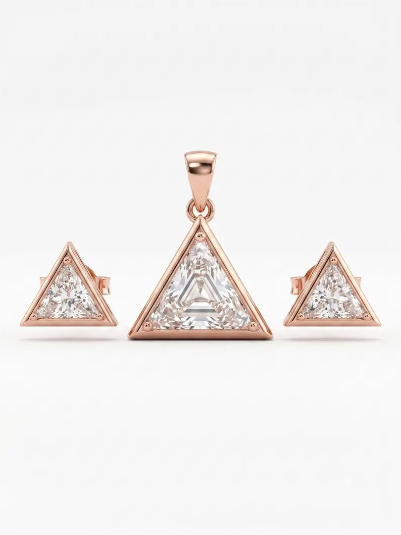 A rose gold jewelry set featuring a central triangle pendant and two matching triangle stud earrings, each set with clear gemstones, displayed on a clean white background.