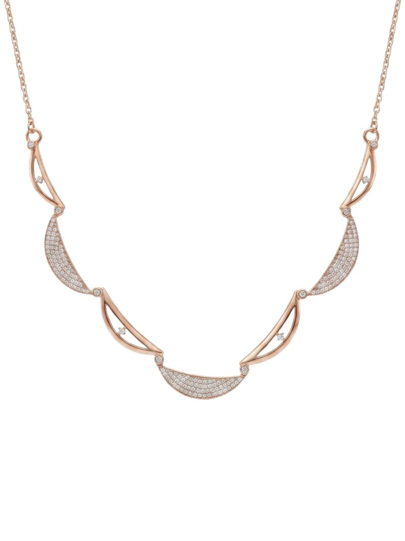 Rose gold necklace with a series of pavé crescent moon and leaf-shaped elements on a white background.