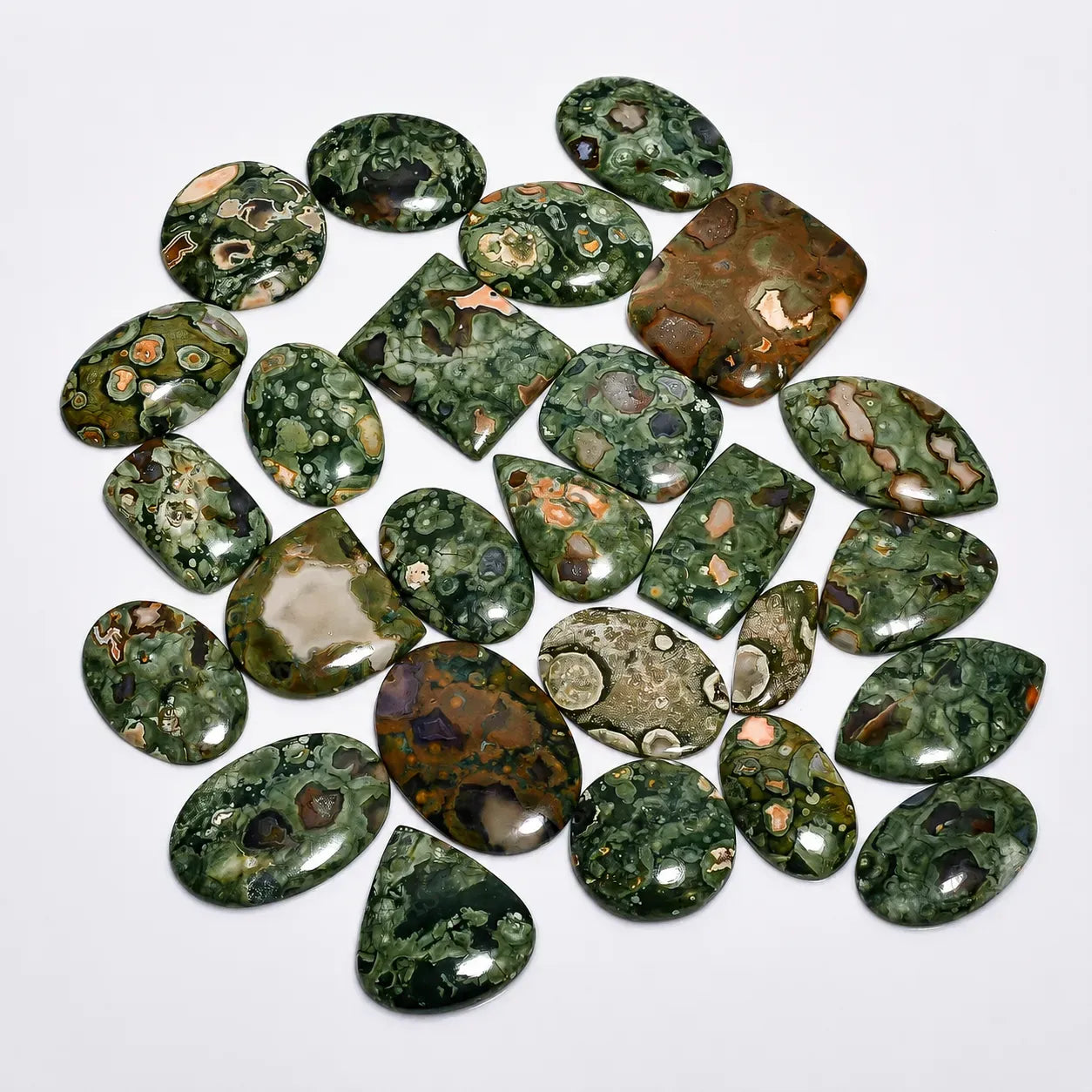 Collection of green and brown marbled stones on a white background