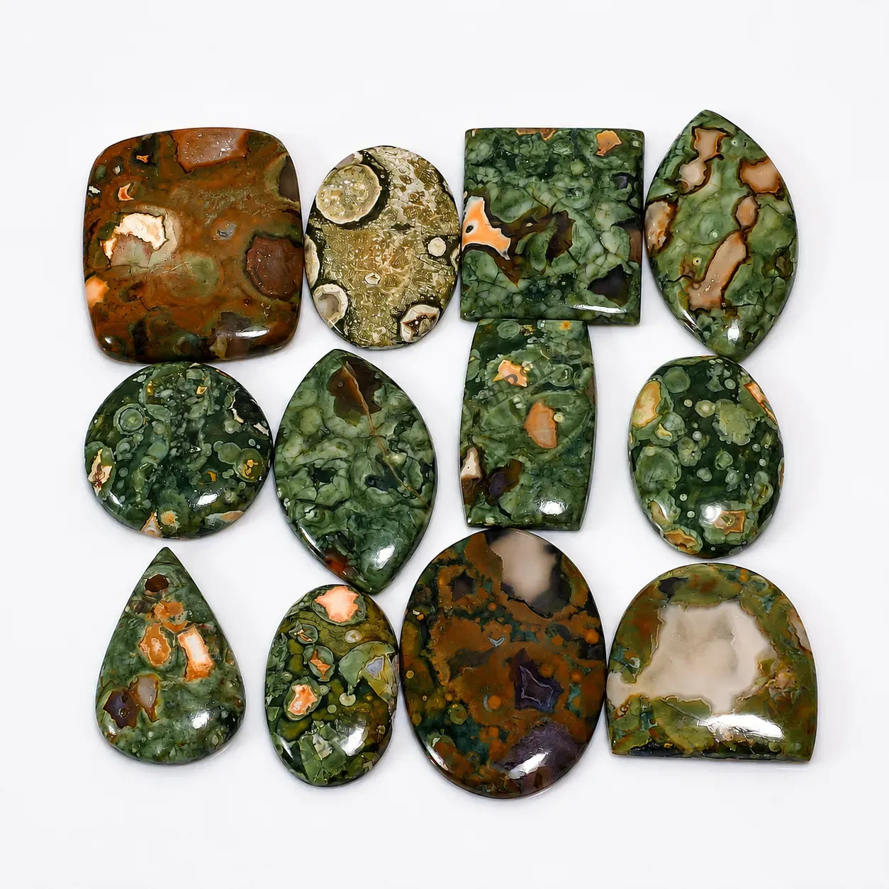 Collection of green and brown marbled stones on a white background