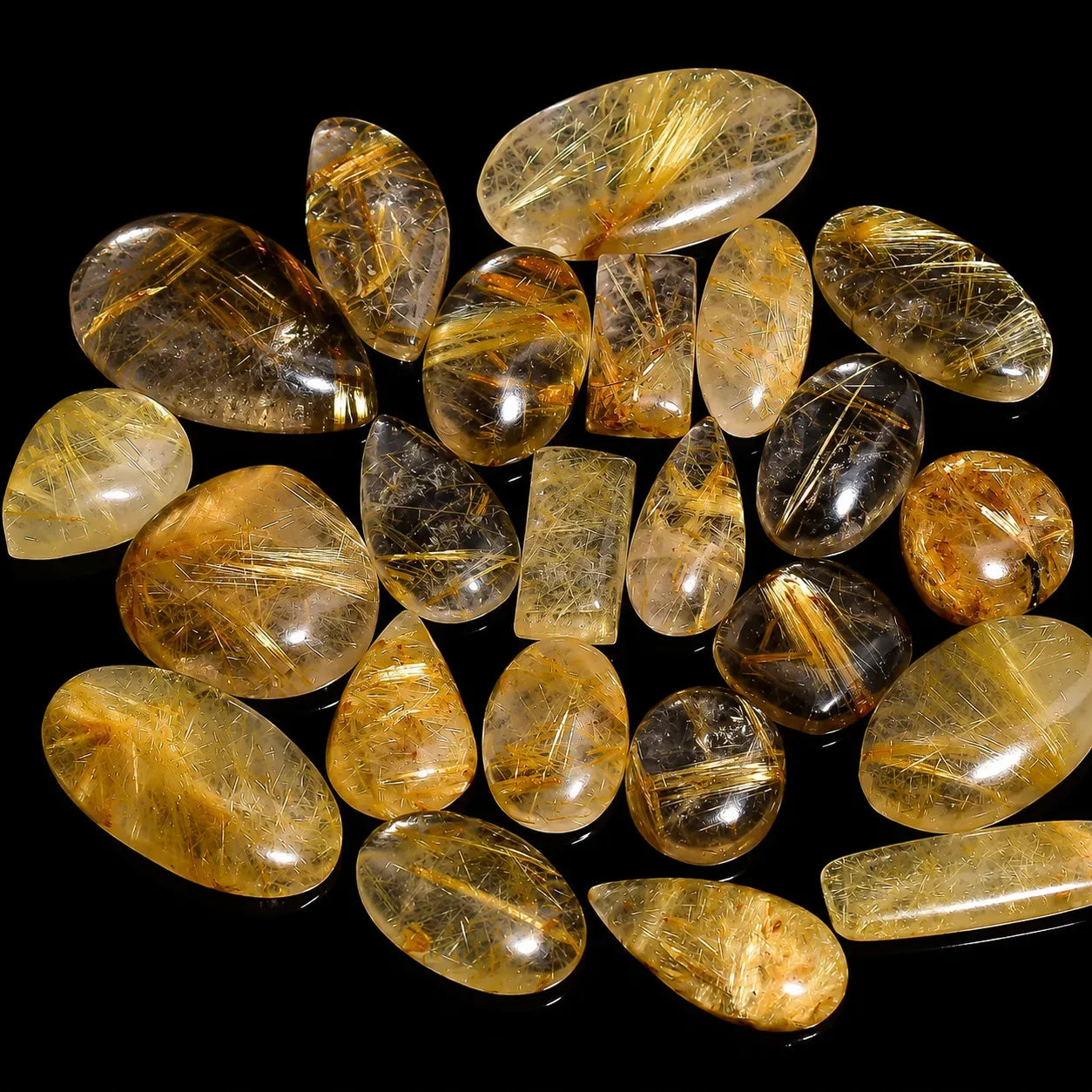 Collection of yellowish-brown gemstones on a black background