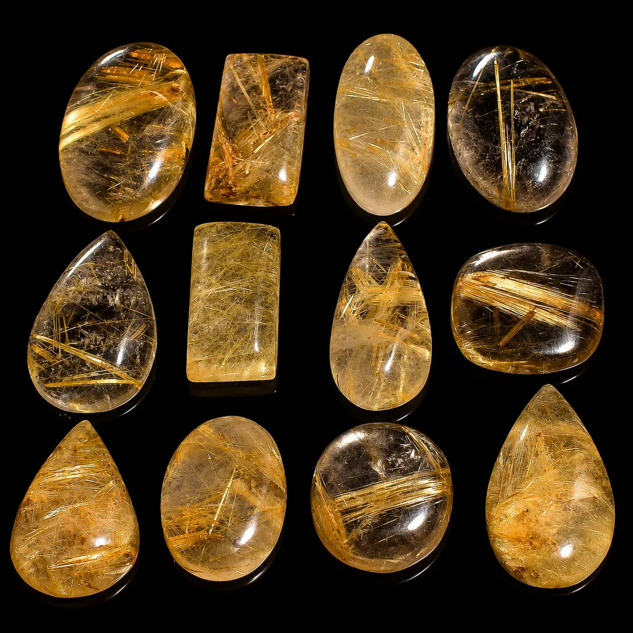 Collection of yellowish-brown gemstones on a black background