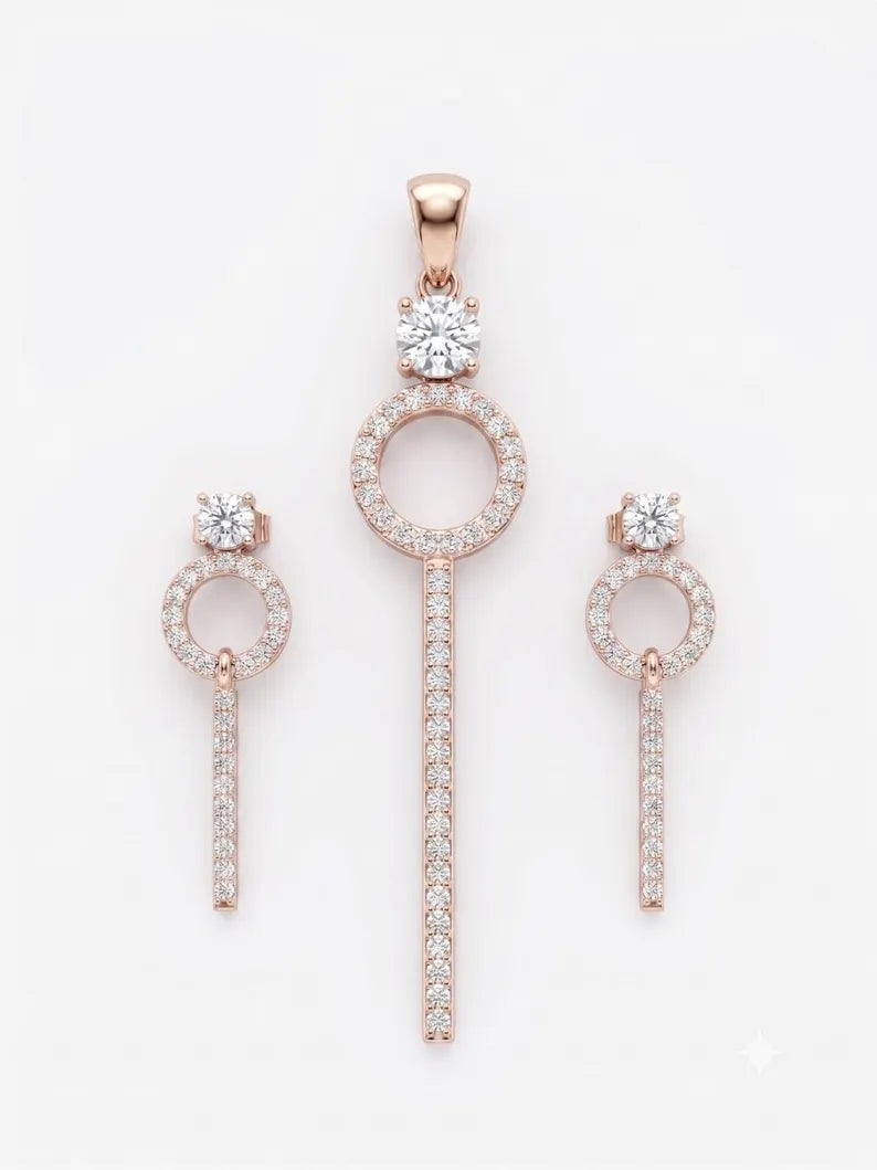 Rose gold jewelry set featuring a pendant and two matching drop earrings, each with a circular pavé setting, a round-cut center stone, and a vertical pavé-studded bar, displayed on a clean white background.