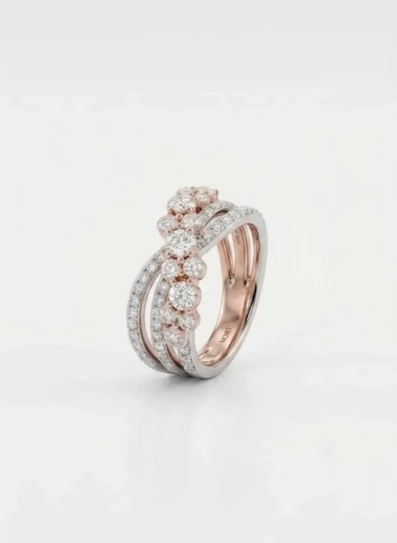 Angled view of a two-tone crossover ring showing the rose gold plated inner band and pave-set CZ rows
