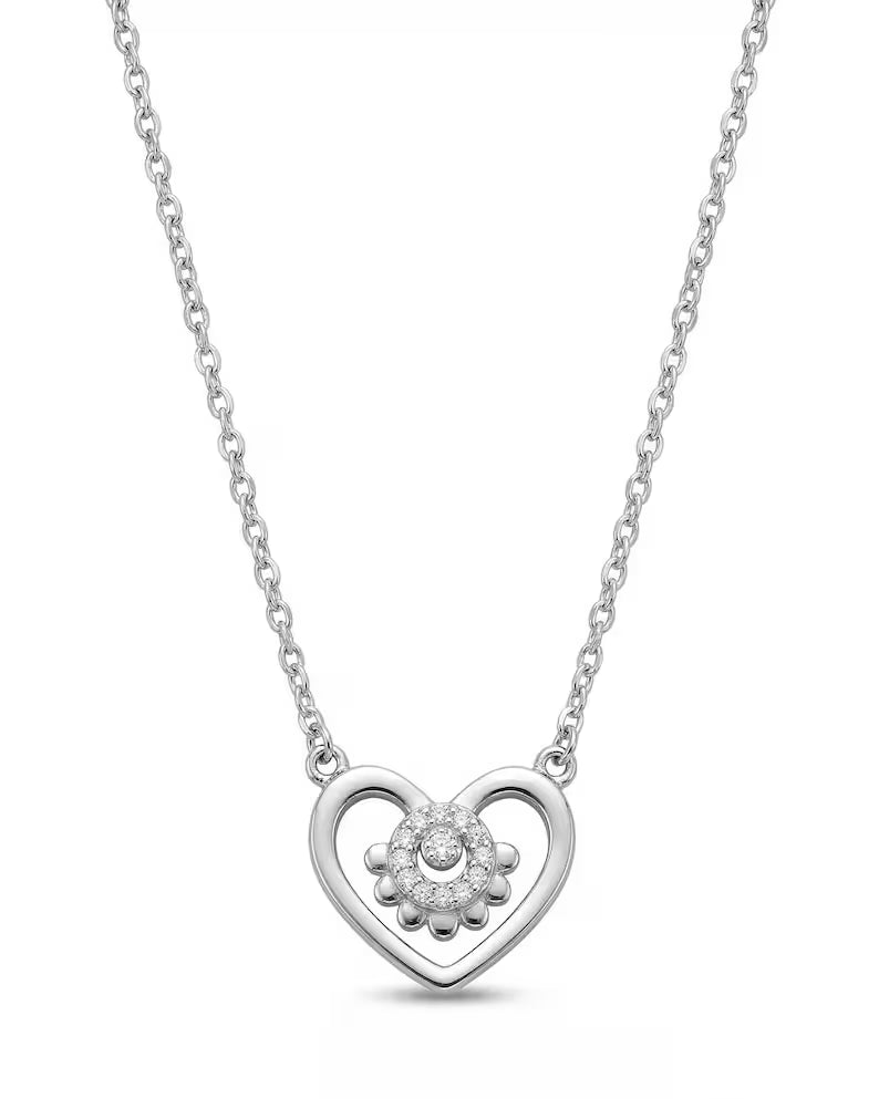 A silver heart-shaped pendant necklace featuring a small clear crystal flower design in the center, suspended from a delicate silver chain against a white background.