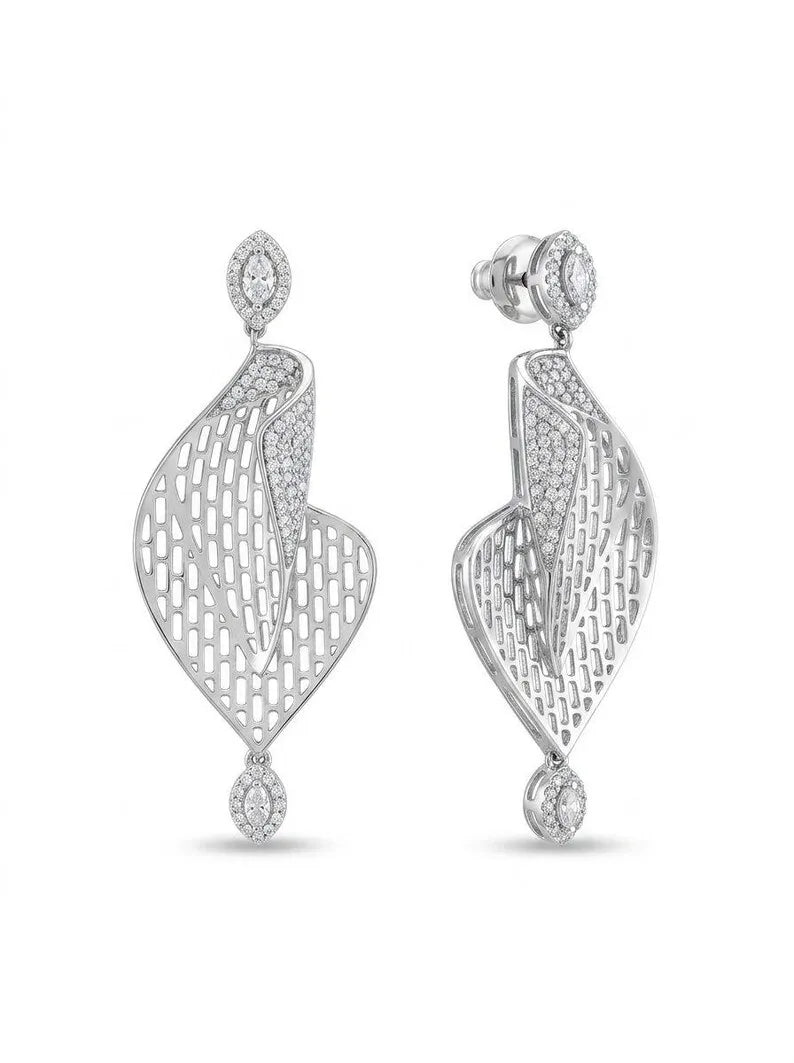 A pair of silver-toned drop earrings with intricate openwork filigree patterns and small clear stones, shown against a plain white background.