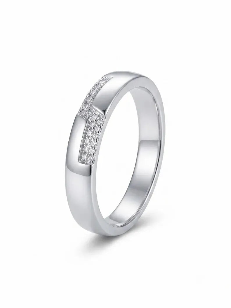 Close up of sterling silver pave band ring with diagonal stone accent on fabric background