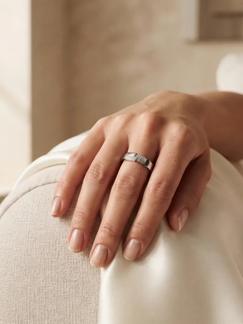 Close up of hand wearing modern minimalist pave band ring in sterling silver