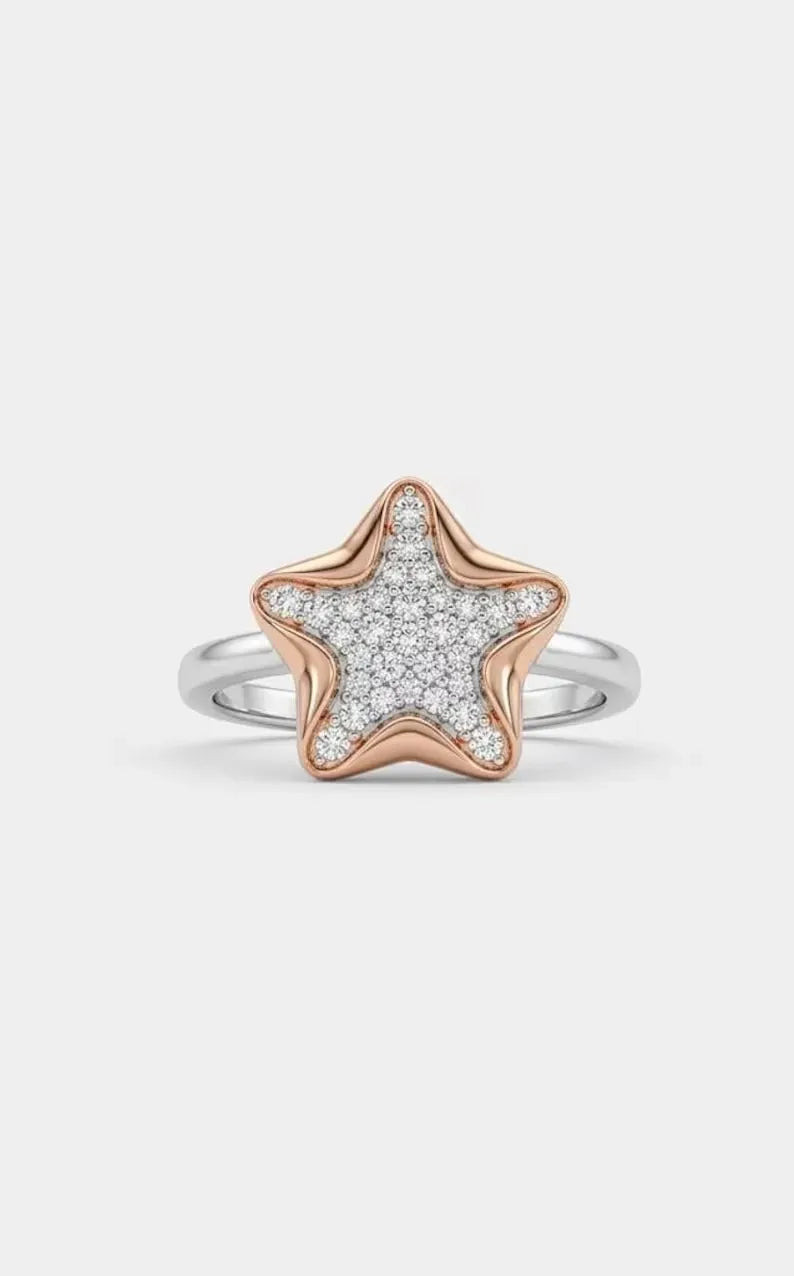 Front view of sterling silver star ring featuring rose gold star charm with pave set cubic zirconia stones