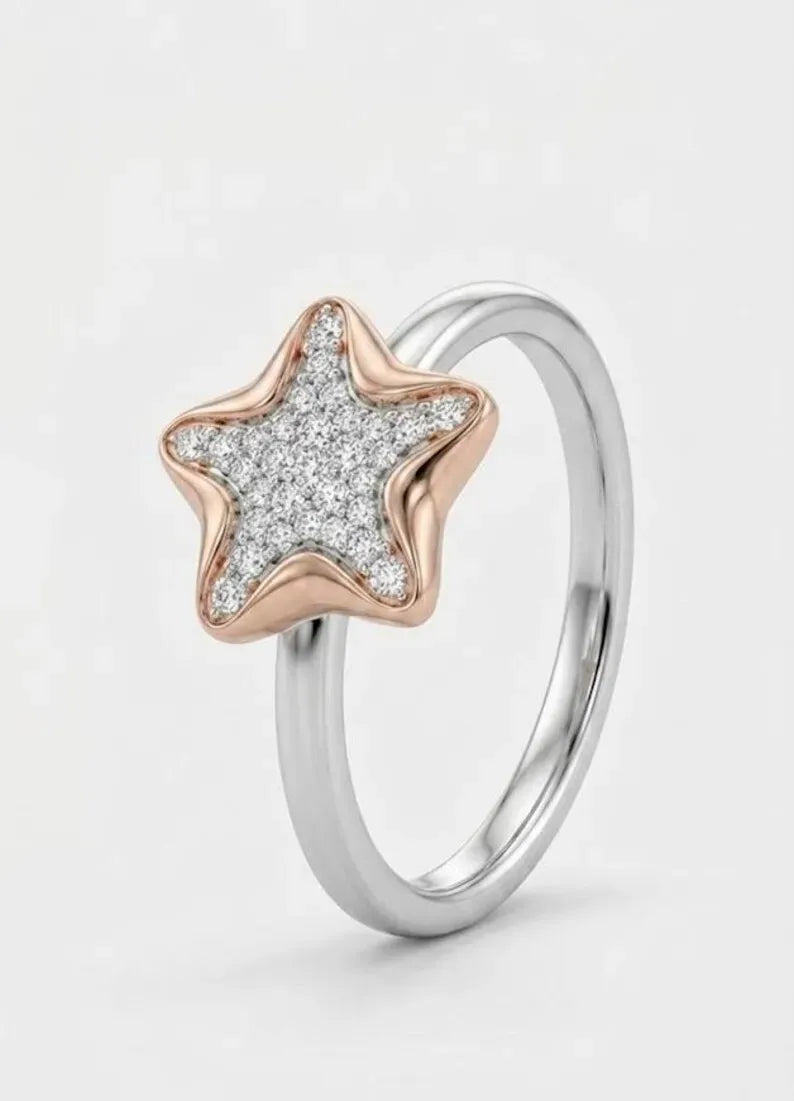Side angle view of dainty sterling silver star ring with rose gold plated CZ star for women