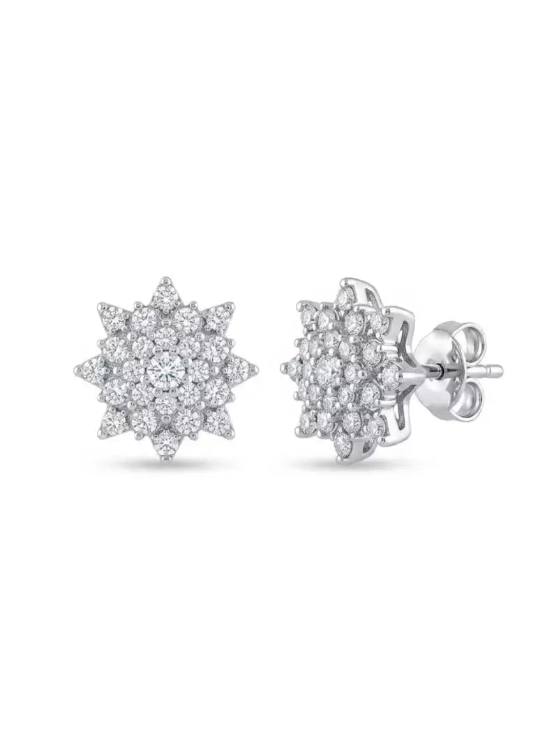 Starburst pave cluster stud earring worn on ear, close-up