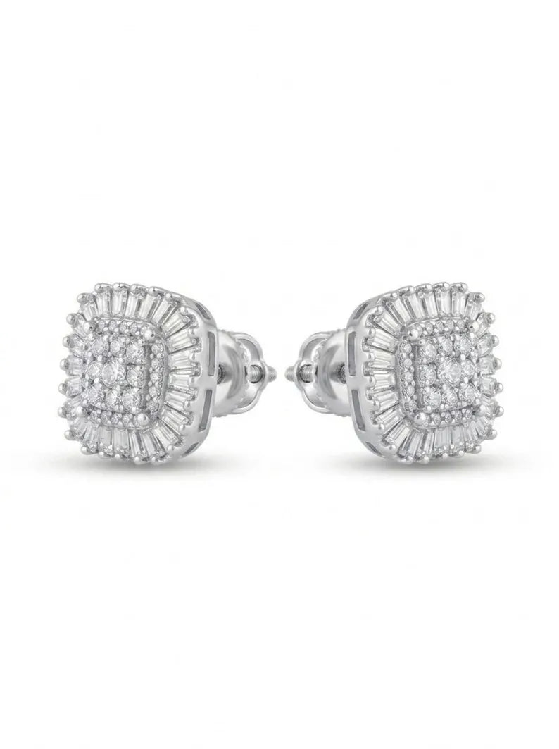 A pair of silver-toned square stud earrings with multiple rows of clear baguette and round stones, shown on a plain white background.