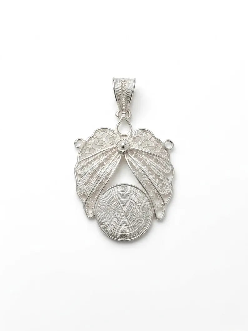 A silver pendant featuring a stylized butterfly with delicate filigree wings and a circular spiral motif below, displayed on a clean white background.