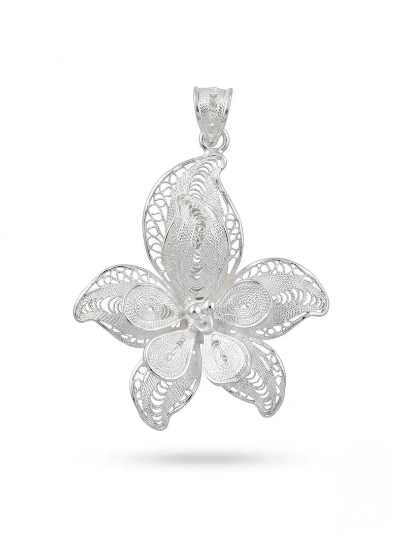 A silver filigree flower pendant with intricate openwork detailing and a polished bail, shown against a plain white background.
