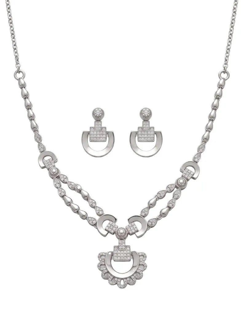 Silver-tone jewelry set featuring a necklace and matching earrings with crescent-shaped pendants and pavé-set clear stones, displayed on a plain white background.