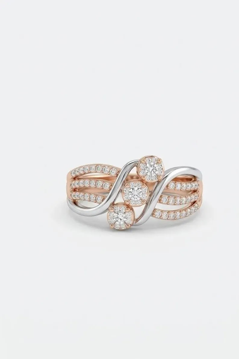 Close up of rose gold and silver crisscross ring with three round CZ clusters