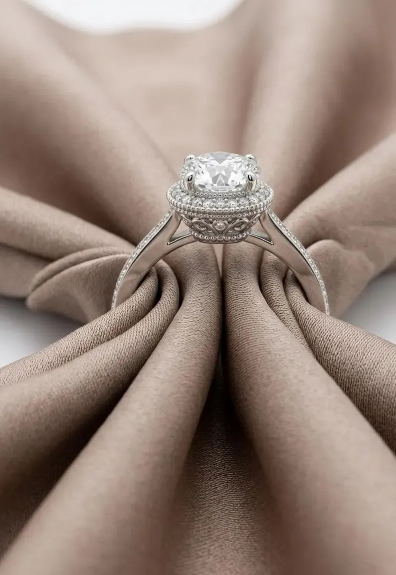 Silver engagement rings: low-angle view of a 925 sterling silver halo ring with round CZ center and scrollwork gallery