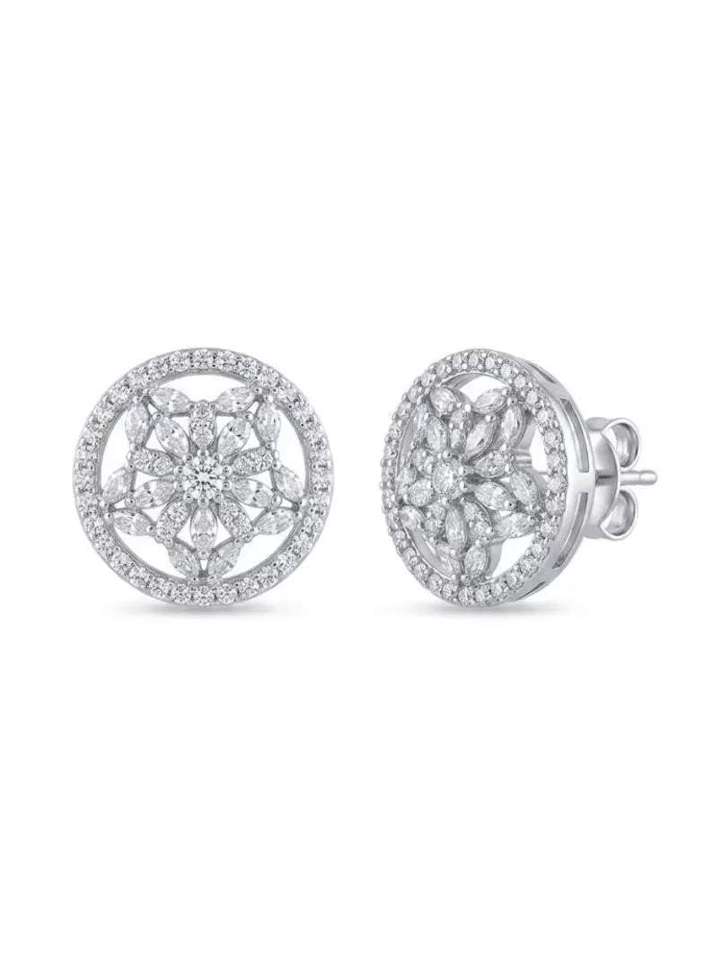 A pair of round silver stud earrings with intricate floral pavé detailing and clear gemstones, shown from both front and side angles on a white background.