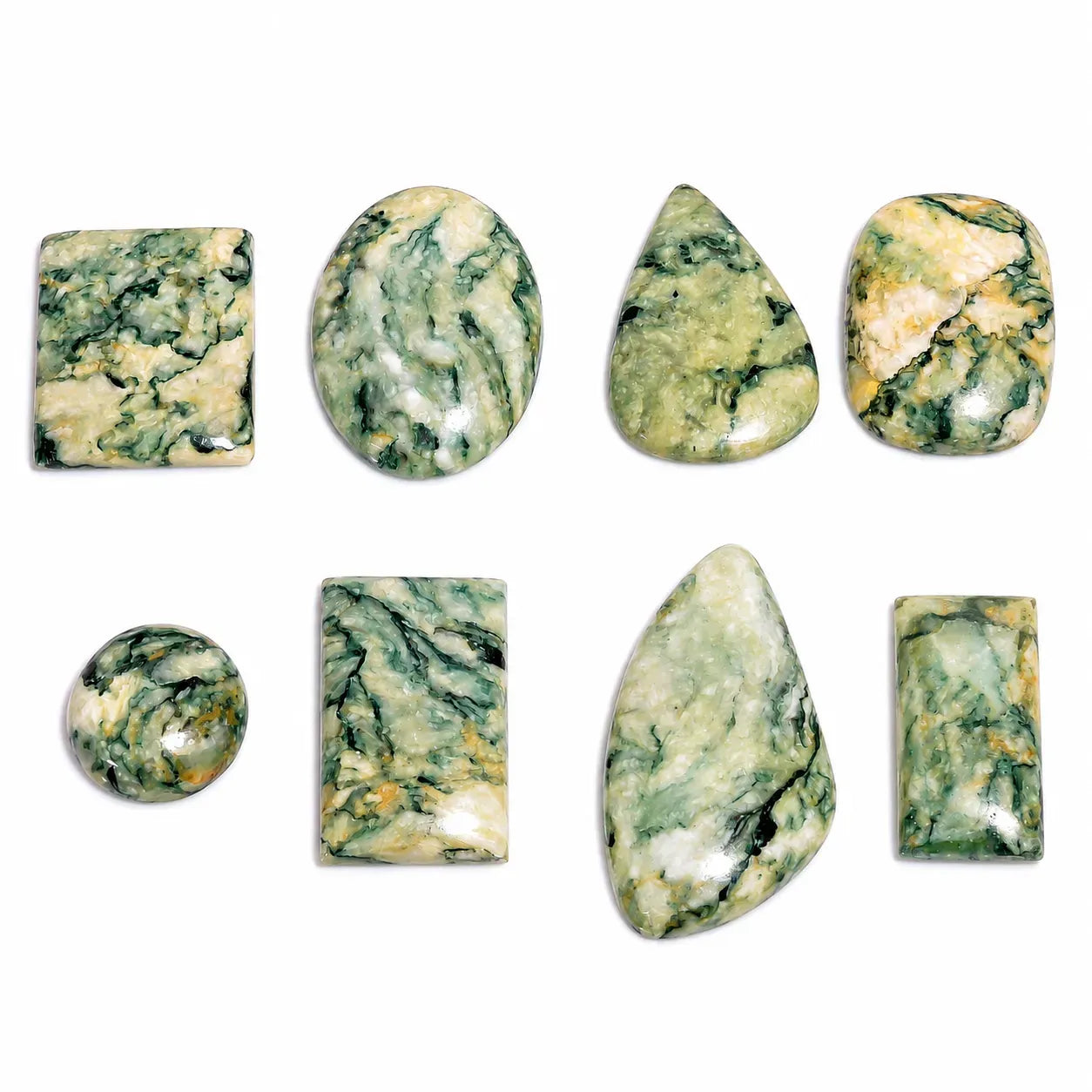 Collection of green and white marbled stones on a white background