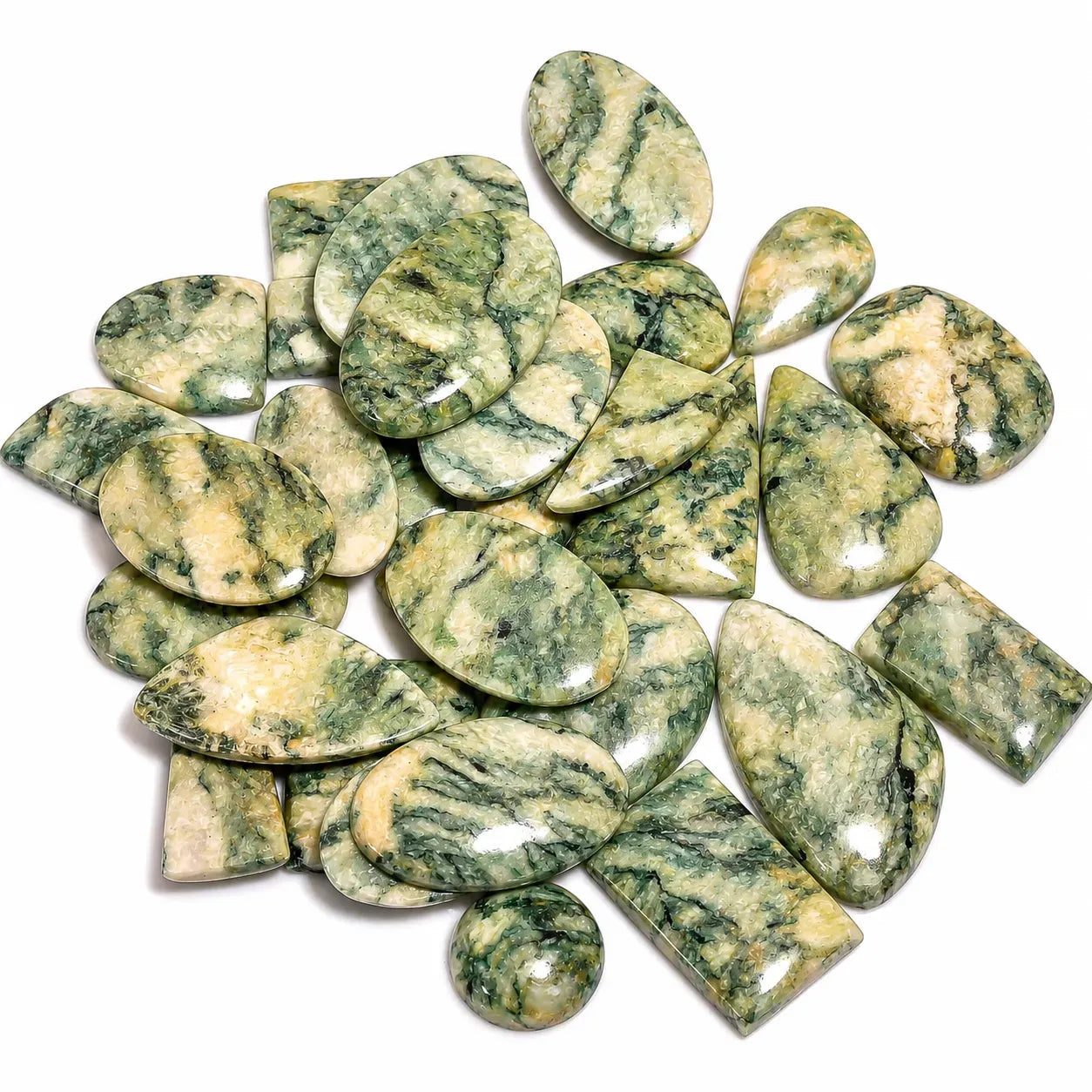 Collection of green and beige marbled stones on a white background