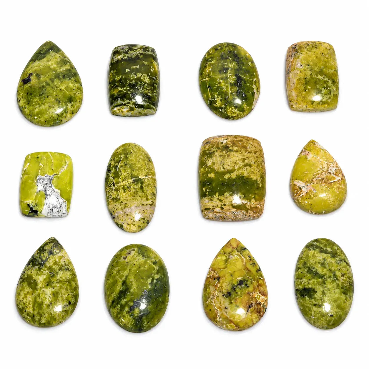 Collection of green and yellow marbled stones on a white background