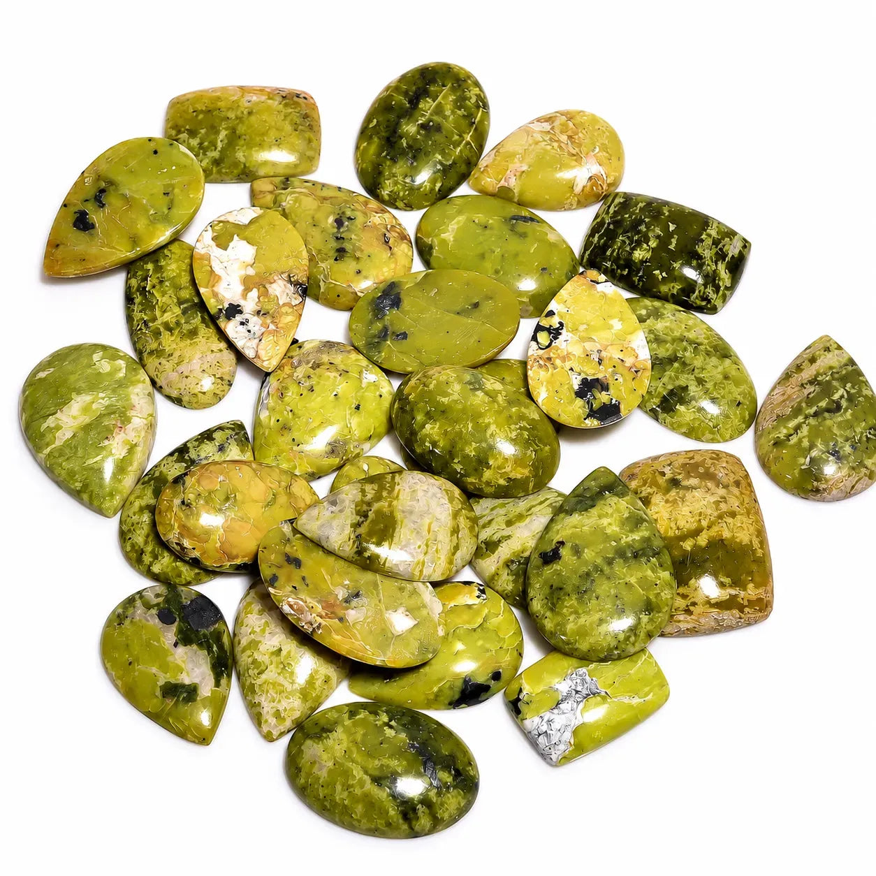 Collection of green and yellow stones on a white background