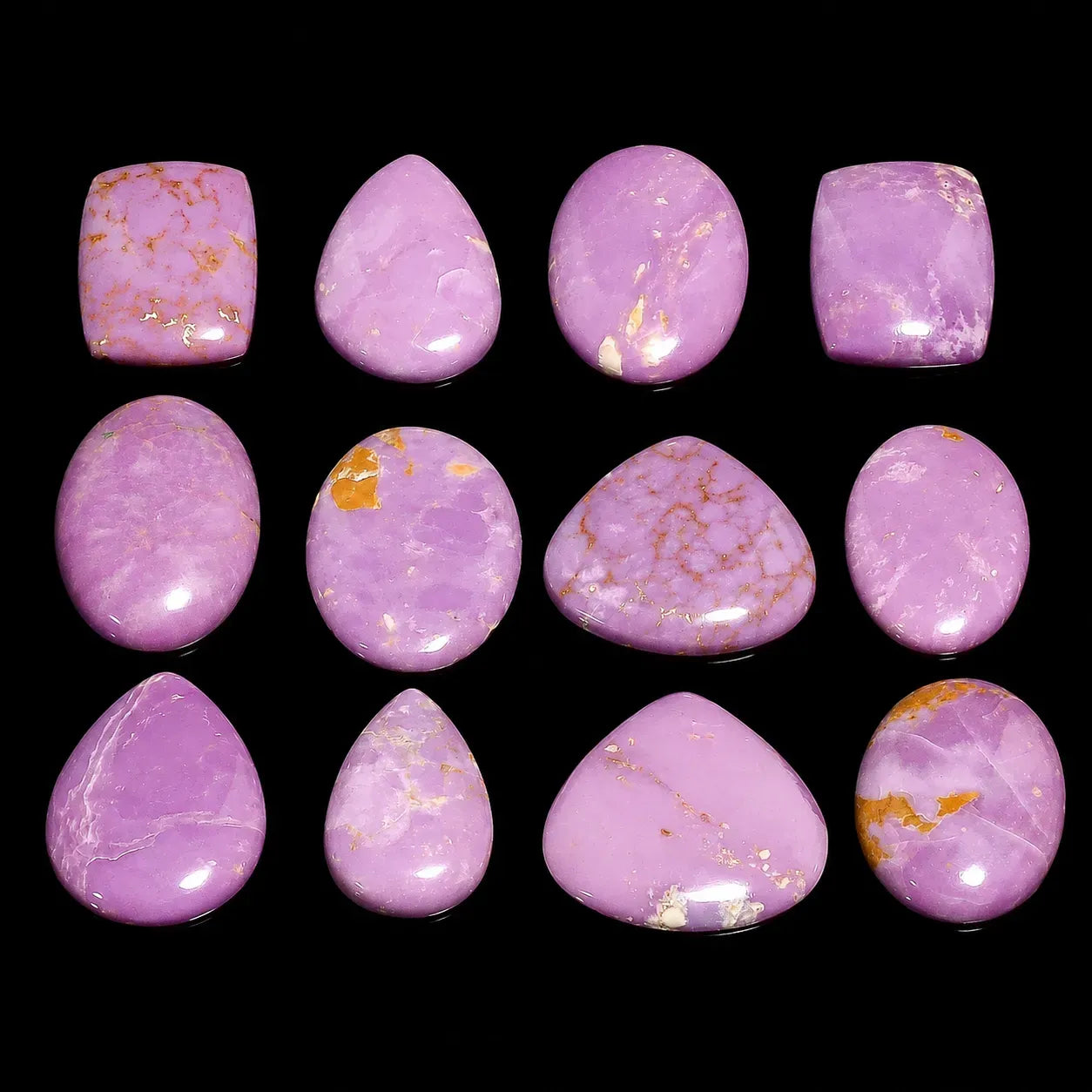 Purple marbled stones with gold flecks on a black background