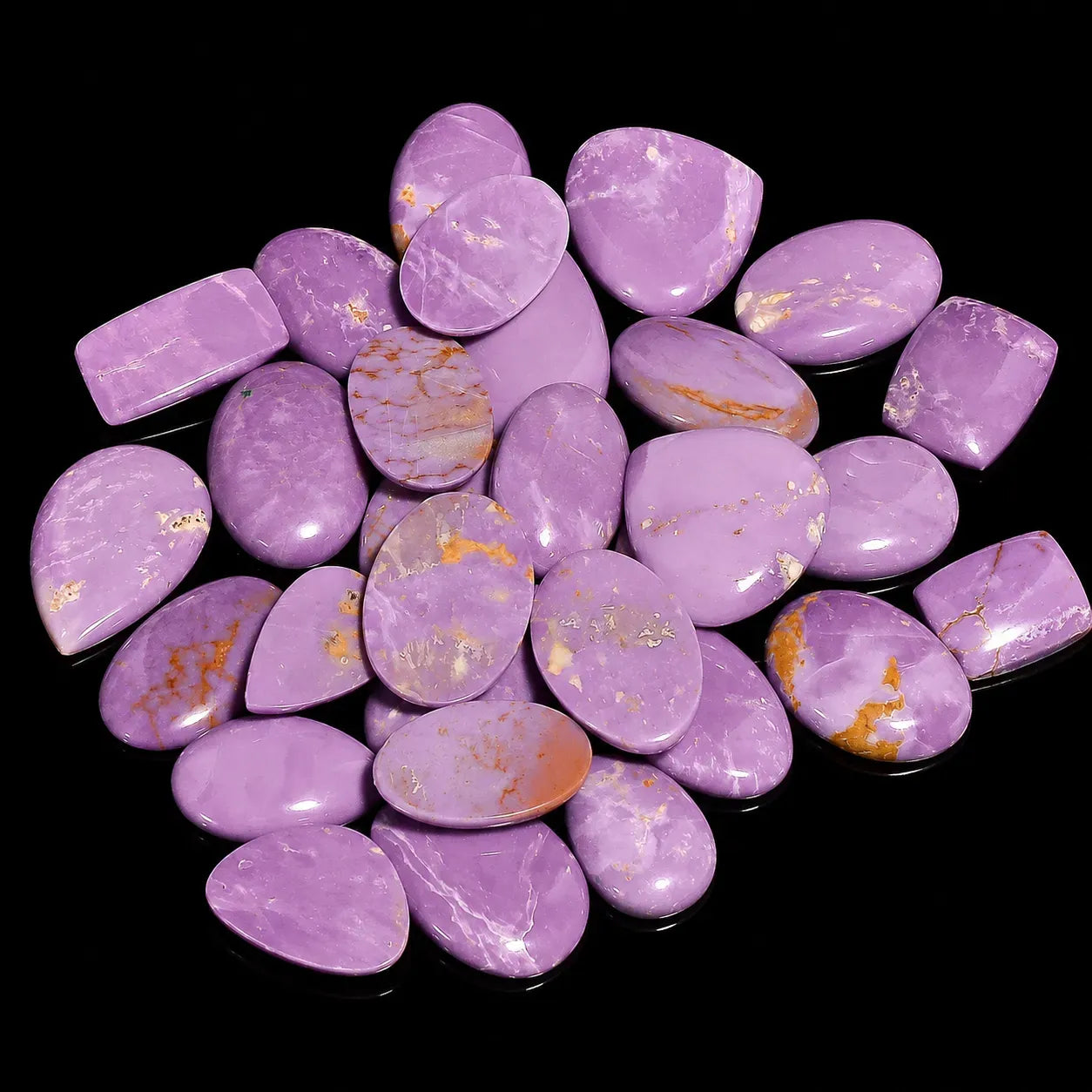 Purple stones with gold veins on a black background