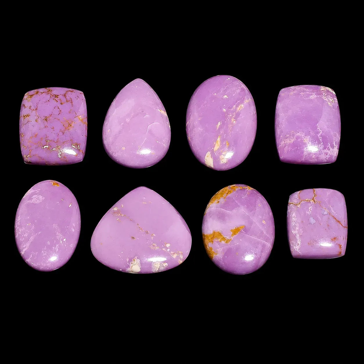 Set of purple marbled stones with gold veins on a black background